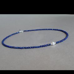 This Vibrant Blue Necklace Was Set Up Using 3.5 Mm Faceted Lapis Lazuli Rondelles, Sterling Silver Findings And A Natural White Pearl. Materials: ~ 3.5 Mm Lapis Lazuli Faceted Rondelles ~ White Natural Round Pearl. ~ Sterling Silver Findings ~ 16” Inches Long Plus 1” Inch Extender Chain Lapis Lazuli Is An Ancient Stone, Used For Manifestation, Wisdom, Truthfulness, Openness, Communication, Inner Power, Intuition, Spiritual Evolution, Virility, Self-Confidence, Objectivity, Dreams, Purity, Sereni Elegant Blue Faceted Necklaces, Elegant Blue Faceted Necklace, Blue Lapis Lazuli Pearl Necklace Gift, Elegant Lapis Lazuli Necklace With Faceted Beads, Elegant Lapis Lazuli Crystal Necklace With Gemstone Beads, Elegant Blue Lapis Lazuli Crystal Necklaces, Blue Faceted Lapis Lazuli Jewelry, Elegant Blue Crystal Necklaces With Gemstone Beads, Elegant Blue Gemstone Bead Crystal Necklace