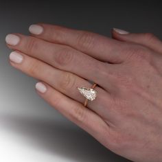 a woman's hand with a diamond ring on it