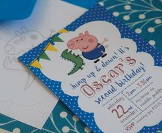 a peppo pig birthday party with blue and white paper on the table, including an envelope