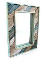 a wooden frame with a mirror on the inside and bottom part cut out to look like strips of wood