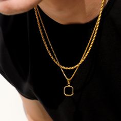 The black onyx pendant on a gold round box chain is a striking and sophisticated piece of jewelry. The pendant showcases a sleek and polished black imitation onyx stone, renowned for its deep black color and smooth surface. The stone is expertly set in a luxurious gold bezel, accentuating its elegance and creating a captivating contrast. The pendant gracefully hangs from a gold round box chain, featuring interconnected square links that lend a modern and stylish appearance. The chain perfectly c Black Rope Chain Necklace As Gift, Black Rope Chain Necklace For Gift, Elegant Black Rope Chain Necklace, Black Pendant Chain Necklace, Tarnish Resistant, Black Tarnish Resistant Pendant Chain Necklace, Black Tarnish Resistant Pendant Necklace, Black Tarnish-resistant Pendant Chain Necklace, Modern Gold Onyx Jewelry, Black Box Chain Necklace For Formal Occasions