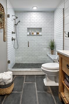 a white toilet sitting next to a walk in shower