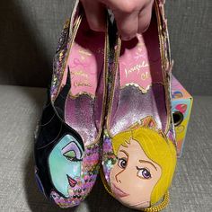 Irregular Choice X Disney's Sleeping Beauty Touch The Spindle! Heels. Limited Edition From The Disney Princess Collection. Pastel Rainbow Sequin Upper Mid-Heel. One Shoe Features Aurora Applique On The Toe With Pink Castle Applique On The Side, Pink And Blue Glitter And A Heel Made To Resemble Her Crown. The Other Shoe Features Maleficent Applique On The Toe, Her Raven Diablo On Her Staff On The Side Amid Purple Glitter Flames And A Heel With Even More Flame Applique. Gold Heel Cap. Cushioned Inner. Exclusive Printed Soles. Flame Applique, Disney Princess Collection, Pink Castle, Irregular Choice Shoes, Disney Sleeping Beauty, Irregular Choice, Princess Collection, Heel Caps, Gold Heels