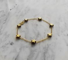 Morning Star. This bracelet is composed of 14K gold vermeil delicate chain and gold plated hematite tiny star charms, that shine and glow. So pretty and easy to wear! It also makes a very cute gift! Not sure which length to buy? We can add a 1 inch extender chain. Just write a note at checkout! ❈ We send all our items with registered mail. ❉ Due to the organic nature of stones, there might be a slight variation in colour, size and shape. ✺ All items come packaged in a quality velvet pouch ready Adjustable Gold Chain Bracelet With Star Charm, Adjustable Gold Star Chain Bracelet, Adjustable Gold Star-shaped Chain Bracelet, Gold Star Charm Chain Bracelet, Gold Chain Bracelet With Star Charm, Gold Celestial Charm Bracelet As A Gift, Gold Star Bracelets For Everyday, Gold Charm Bracelet With Star Charm As A Gift, Gold Bracelets With Star Charm For Gift