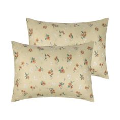 two pillows with flowers on them sitting next to each other