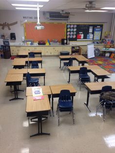 an empty classroom with desks and chairs