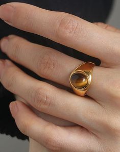 This statement oval stone ring featuring a glossy gem that has a big personality, just like you. Crafted in 18k gold on titanium steel, this oval stone ring is the perfect centerpiece of a sharp look.• S P E C I F I C A T I O N •Finish: 18K PVD gold on titanium steelGemstone options: Black oxyn, Brown tiger eye, Green jadeFront stone rim dimension: approx. 8 x 10 mmDue to the unique nature of gemstones, exact colors and patterns may differ slightly from the p Oval Stone Ring, Eye Green, Big Personality, Brown Tiger, Brown Tiger Eye, Unique Nature, Couple Jewelry, Demi Fine Jewelry, Eye Ring