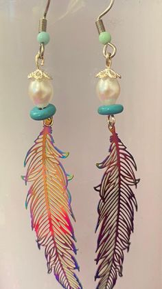 Rainbow large stainless steel feather earrings with turquoise and pearl beads. These stunning earrings are designed to captivate with their mesmerizing color and delicate feather details , adding a touch of elegance to your style. Feather Charm Earrings, Multicolor Feather Earrings For Gift, Multicolor Feather Earrings Gift, Turquoise Feather Earrings, Rainbow Feather, Beaded Earrings Diy, Earrings Colorful, Earrings Diy, Colorful Feathers