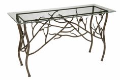 a glass and metal table with branches on it