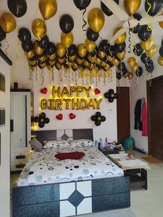 a bedroom decorated for a birthday with balloons and streamers