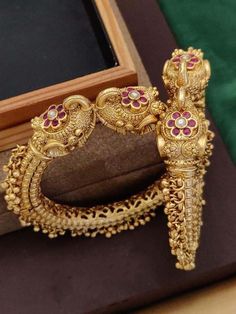 Finish your look with this beautiful peacock motif openable ghunghroo (tiny gold beads) bangles with any traditional attire for any occasion. These fully carved bangles are studded with cz stones. Rajwadi Kangan, Gold Patla, Pacheli Bangles, Peacock Bracelet Bangles.  WHAT GOES IN  👉🏻Gold Plated on High quality Brass matte gold finish. 👉🏻Size Available: 2.4 / 2.6 & 2.8 👉🏻Size: 2.4 openable fits bangle size 2.6 and size 2.6 openable fits 2.8 bangle size. 💕CARE TIP  1. Keep away from moistu Luxury Traditional Chandbalis With Peacock Design, Elegant Peacock Design Bangle For Festivals, Traditional Peacock Design Wedding Bracelets, Traditional Peacock Design Bracelets For Wedding, Traditional Wedding Bracelets With Peacock Design, Temple Jewelry Bracelet With Peacock Design, Temple Jewelry Bracelet With Peacock Design For Gift, Peacock Design Bangle For Wedding, Traditional Peacock Design Bangle For Festivals