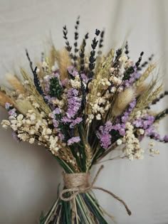 a bunch of dried flowers in a vase