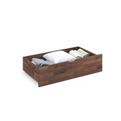 a wooden drawer with two folded towels in it