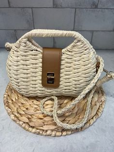 This Rattan Woven Hand Bag is the perfect accessory for those who value unique and playful style. Made with high-quality rattan, this bag is both durable and trendy. Arm band is detachable making a whole different style bag. Carry all your essentials in this lightweight, one-of-a-kind bag. Trendy Rectangular Straw Bag With Adjustable Strap, Versatile Satchel Straw Bag For Vacation, Trendy Natural Bags With Detachable Strap, Trendy Summer Straw Bag With Detachable Strap, Summer Straw Crossbody Bag, Trendy Shoulder Bag With Detachable Strap In Natural Color, Trendy Crossbody Satchel For Vacation, Versatile Beige Straw Bag With Adjustable Strap, Rectangular Straw Bag With Detachable Strap For Vacation