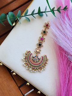 This stunning Bindiya, the perfect accessory to add a touch of elegance and glamour to any outfit. Handcrafted with precision and attention to detail, each Bindiya is a unique work of art that will make you stand out in any crowd. Made with high-quality materials, our Bindiya is designed to be comfortable and easy to wear, ensuring that you can enjoy it all day long without any discomfort. The intricate designs and vibrant colors will complement any outfit, from traditional Indian wear to contem Chandbali Jewelry With Zari Work For Party, Bollywood Bridal Sets With Latkans For Festive, Multicolor Chandbalis With Zari Work For Wedding, Multicolor Zari Work Chandbalis For Wedding, Bollywood Kundan Tikka With Latkans, Elegant Multicolor Tikka For Wedding, Bohemian Kundan Necklace With Stone Work, Bohemian Kundan Tikka With Stone Work, Multicolor Stone Work Jhumkas For Wedding