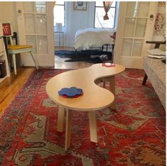 a living room filled with furniture and a red rug