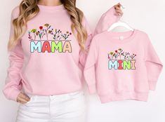 This cute floral matching mommy and me sweatshirt makes a great gift for Dias De Las Madres, a baby shower, a birthday, or any special occasion. Find more inspiring mother-and-daughter bonding matching outfits. How to order: Choose product/size & color then add to cart. You'll need to repeat this step for each order. Finally, click on the cart to check out.  SEE THE SIZE CHART FOR MEASUREMENTS Adult Unisex crewneck sweatshirt is ideal for any situation, a heavy blend crewneck sweatshirt is pure Family Matching Sweatshirt With Name Print For Mother's Day, Cute Long Sleeve Tops For Mother's Day, Mother's Day Pink Cotton Sweatshirt, Pink Cotton Sweatshirt For Mother's Day, Matching Long Sleeve Tops For Mother's Day, Cute Long Sleeve Tops, Mama Tee Shirts, Daughter Bonding, Monogram Baby Blanket