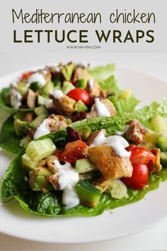 lettuce wraps with chicken, tomatoes and cucumber on top are served in a white plate