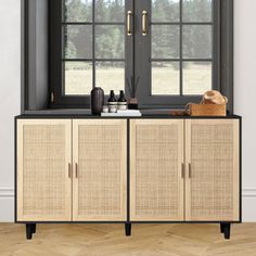 the sideboard is made from rattan and has two large windows with black frames