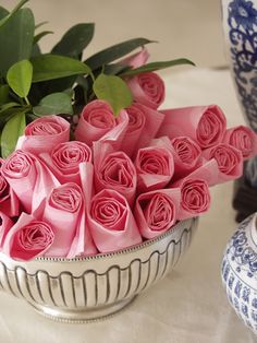 a bouquet of pink roses sitting on top of a table