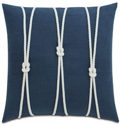 a blue pillow with white rope on it