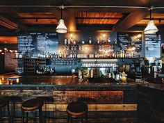 an empty bar with stools in front of it