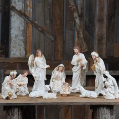 a group of figurines sitting on top of a wooden table next to each other