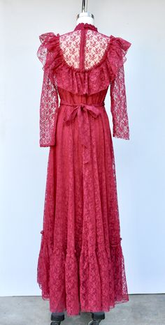 "Vintage Lace Maxi Dress in Vibrant Cranberry Color! Perfect for a vintage wedding !! This is STUNNING !! *Ruffled *Floral Lace *Lace is see through on neck and sleeves *Long Sleeves - Please note that the right sleeve was cut short - do not know why as the other one is original length. This is how we found it and sold As Is. Pretty simple job for a seamstress to shorten the other one to make them the same length. Priced accordingly! *Zip up on back *Floor Length *Lined - Lace even on back part Vintage Lace Dress With Long Sleeves, Vintage Formal Dress With Ruffles, Vintage Lace Floor-length Dress, Floor-length Ruffled Vintage Dress For Wedding, Vintage Floor-length Lace Dress, Lace Dress With Ruffles For Vintage Events, Vintage Maxi Wedding Dress, Vintage Wedding Maxi Dress, Feminine Ruffled Dresses For Vintage Events