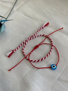 Red Bracelet With Martenitsa, Evil Eye Bracelet, Red String Bracelet, Adjustable Protect Bracelet. Handmade with love.  Set of 2 Bracelet, 1 piece of red-white cotton rope Martenitsa. Adjustable bracelet with 1 red rope and glass evil eye bead. You can wear the Red Bracelet With Martenitsa on your wrist by making a wish. Martenitsa is an old Bulgarian tradition. The Evil Eye symbolizes the jealous and envious look of others, which according to the popular belief, would have the power to cause va Red Round Beads Bracelet As Gift, Adjustable Red Charm Bracelet, Adjustable Red Round Charm Bracelet, Adjustable Round Red Charm Bracelet, Handmade Red Beaded Bracelets For Gift, Red Bohemian Charm Bracelet For Gift, Bohemian Style Red Charm Bracelet For Gift, Handmade Red Adjustable Friendship Bracelets, Red Adjustable Beaded Bracelets As A Gift