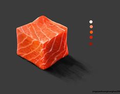 a piece of meat sitting on top of a black surface next to an orange cube