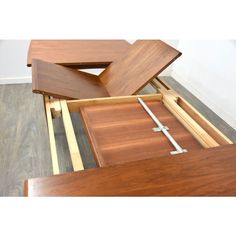 a wooden table with two pieces of wood on top and one piece of metal in the middle