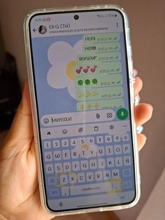 a person holding up a cell phone with the keyboard on it's display screen