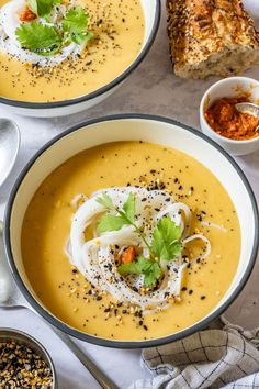 two bowls filled with soup and topped with sour cream, garnished with parsley