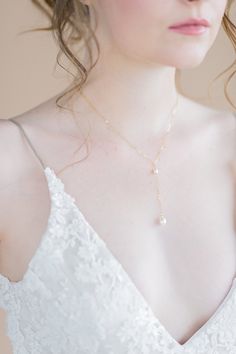 "Style Name: Emily Inspired by and named after one of our brides, the Emily necklace is the perfect simple delicate and modern necklace for a low v neck gown (or every day!) This beautiful delicate cable chain necklace features a Y droplet of our signature freshwater pearl linked with a tiny freshwater pearl at the Y. This necklace is just minimal perfect! ♥ The Fine Details * Hand wire wrapped link of a small 5mm freshwater pearl linked to a chain drop with a single 7-8mm AAA Freshwater pearl c Elegant Bridal Lariat Necklace, Delicate Bridal Necklace For Formal Occasion, Elegant Lariat Backdrop Necklace For Wedding, Delicate Adjustable White Drop Necklace, Delicate Pearl Chain Jewelry For Wedding, Adjustable Pearl Drop Bridal Necklace, Delicate White Adjustable Drop Necklace, Adjustable Bridal Necklace With Pearl Drop, Dainty Adjustable Bridal Necklace For Wedding