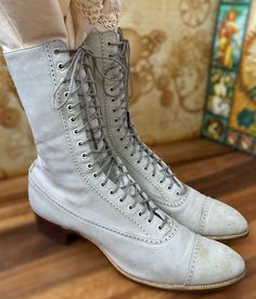 "One of many Edwardian mens/women's boots that we have for sale in our Etsy TeaTime shop. A fabulous pair of Antique womens Edwardian \"granny\" boots. An off white color, with just a hint of gray. Unique wingtip style design to the uppers (refer to Photos) made in smooth leather, with naturally distressed details and a lower block heel. 18 grommet hole granny boot. Brown Leather sole.*Refer to last photo and condition comments below for details. Size: REFER TO SIZE CHART INCLUDED no size indica Victorian Boots With Leather Sole, Vintage Fitted Lace-up Boots With Snip Toe, Victorian Almond Toe Fitted Boots, Victorian Style Fitted Leather Boots, Fitted Victorian Leather Boots, Vintage Fitted Cap Toe Boots, Fitted Vintage Cap Toe Boots, Fitted Cap Toe Vintage Boots, Silent Sky