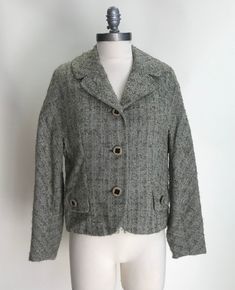 "1950/1960's Women's Green Nubby Tweed Jacket with Dolman Sleeves.  This alluring jacket is in great vintage condition with unique original buttons, a sewn on belt in the back and faux pockets in the front.  There are no tags as to the size or material, however it is a bit big on the dress form it is displayed on.  The form has a bust of 34\" and a waist of 27\".  The material appears to be a wool blend.  The lining is still in impeccable shape. Measurements: Armpit to Armpit:  42\"  (measured flat and then doubled) Waist:  38\"  (measured flat and then doubled) Back:  18\" Sleeve Length:  21.5\"   Back Length:  18\"" Casual Tweed Jacket With Buttons, Retro Tweed Jacket With Buttons For Work, Retro Tweed Jacket For Work With Buttons, Vintage Button-up Tweed Jacket For Fall, Vintage Tweed Jacket With Button Closure For Work, Retro Tweed Jacket With Buttons For Fall, Vintage Wool Tweed Jacket With Button Closure, Vintage Tweed Outerwear For Spring, Vintage Single-breasted Tweed Jacket For Spring