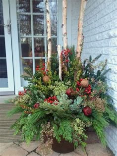 a planter filled with lots of green and red flowers