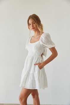 Certified sweetheart in the Hayden Puff Sleeve Babydoll Mini Dress! This darling fit and flare mini dress features puff sleeves, an open back, floral embroidery, and flowy tiered skirt. Cherry on top? This mini dress has pockets! Available in white and baby blue. Pair this summer mini dress with a chic pair of heels to complete the look! Details: 100% Polyester Tie back closure Elastic straps and waist Fully lined Two side pockets Hand wash cold Black Graduation Dress, Graduation Dress College, Pretty Maxi Dress, White Babydoll Dress, Fit And Flare Mini Dress, Short Sleeve Wedding Dress, Sorority Rush, Summer Mini Dress, American Threads