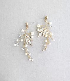 two pairs of earrings with pearls and leaves