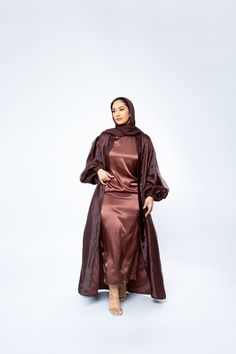 The Organza Abaya is statement outfit for any event. It's super lightweight yet so simple with the prettiest sheen. Complete the look with our matching long sleeve satin slip dress and a pair of strappy heels for a luxe finish or make it into a more casual look. *Please note that the color displayed in the picture might be slightly different due to the color resolution and lighting. Fabric Description & Care: Balloon Sleeves with elastic cuff Double Lined Material: Silk/Organza Dry Clean for bes Elegant Satin Maxi Abaya, Silk Long Sleeve Abaya For Party, Silk Long Sleeve Party Abaya, Elegant Long Sleeve Satin Abaya, Silk Long Abaya For Party, Satin Evening Abaya For Eid, Silk Party Abaya, Eid Evening Satin Abaya, Satin Silk Dress Hijab