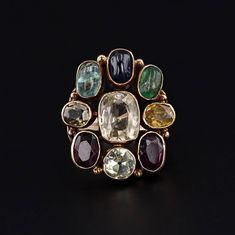 This vintage ring (circa 1960-1970) features assorted gemstones in 14k gold. The gemstones include garnet, zircon, emerald, sapphire, aquamarine, and chrysoberyl.   The face of the ring measures 0.9 inches by 0.8 inches wide and is in very good condition with light surface wear.  The ring is currently a size 6, but it can be resized free of charge. We have many other fantastic offerings of fine jewelry posted on our Etsy store, so please consider browsing our other items. We send all items in in Gemstone Rings Vintage, Costume Jewelry Rings, Jewelry Post, Diamond Flower, Antique Diamond, Vintage Ring, Antique Shops, Bay Window, Gemstone Ring