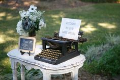 an old - fashioned typewriter with a sign that says welcome to our love story