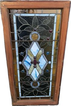 an old stained glass window with flowers on it