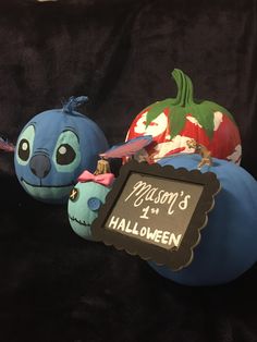 two pumpkins with faces painted on them and a sign that says, mission's 1 halloween