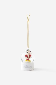 a snow globe ornament with mickey mouse on it hanging from a gold cord