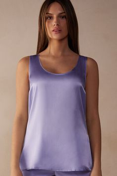 Tank top with wide straps and deep scoop neckline. The front is in pure silk satin and the back is in soft modal. The darts on the bust and the side vents make the fit even more comfortable. Loose fit.
The model is 5’ 9” (175 cm) tall and is wearing a size S.

The silk in this piece is bluesign® certified. Silk Cami Top With Built-in Bra, Elegant Tank Top With Built-in Bra And Wide Straps, Silk Cami Tank Top With Built-in Bra, Sleek Tops With Built-in Bra And Scoop Neck, Elegant Seamless Tank Top With Wide Straps, Stretch Satin Tank Top For Summer, Satin Tank Top With Built-in Bra, Summer Stretch Satin Tank Top, Summer Satin Stretch Tank Top