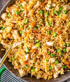 a bowl filled with rice, peas and chicken