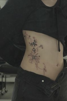 a woman's stomach with flowers on it and the bottom part of her belly