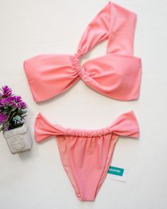 Embrace the warmth of summer with our Guava Pink Bikini Set, a beautiful ensemble that captures the essence of tropical bliss. The top is designed to make a statement with its bold tie-back feature, allowing for a customizable fit, while the matching bottom are adorned with unique stylish details, mirroring the top’s charm. This set is not just about style; it’s also crafted for comfort, made with a luxurious, stretch-resistant fabric that feels as good as it looks. Key Features: • Vibrant guava Tropical Swimwear For Summer Parties, Pink Summer Swimwear For Resort Season, Pink Swimwear For Beach Resort Season, Pink Swimwear For Resort Season Vacation, Pink Swimwear For Beach And Resort Season, Fitted Tropical Swimwear For Resort Season, Tie Backs, Wearable Art, Body Types