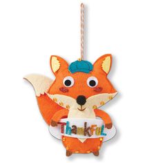 an ornament shaped like a fox with the word thank on it's chest